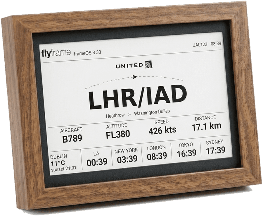 A walnut FlyFrame e-ink display showing a live United flight from London Heathrow to Washington Dulles